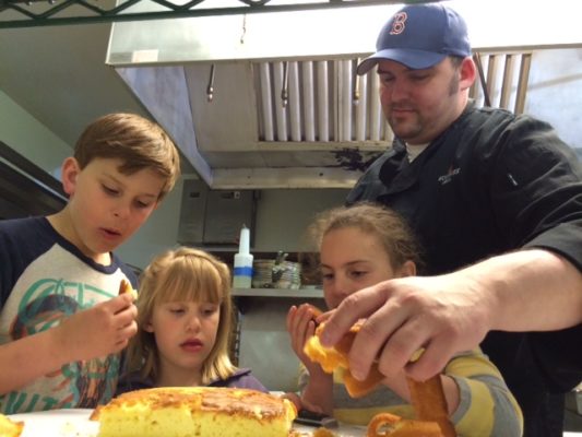 Fireside Chef Blake Schar in the kitchen with his kids. 